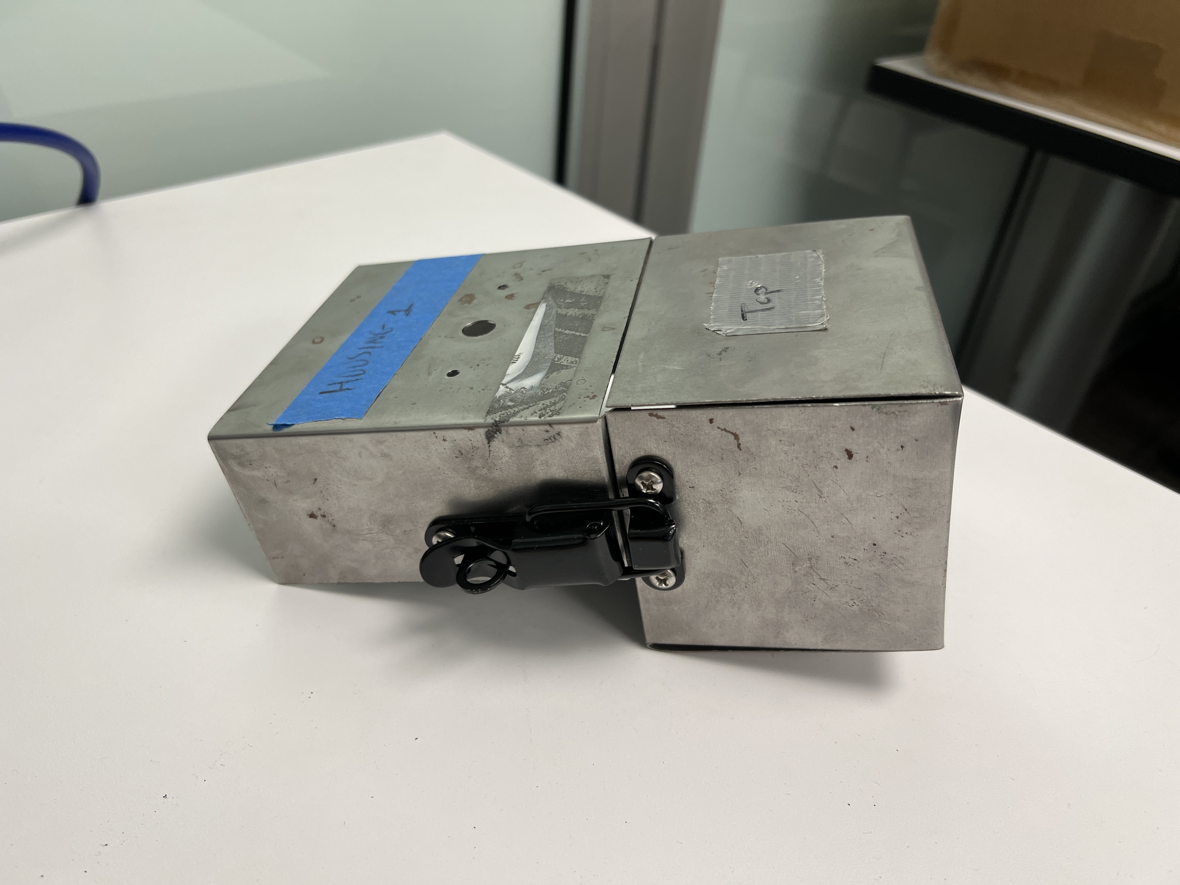 Rejected version of housing that used toggle clamps